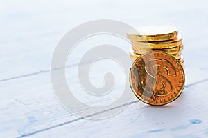 Coin sweet dollar on a wooden white background