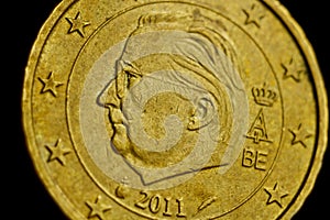 Coin ten euro cent macro isolated on black background. Detail of metallic money close up. EU money