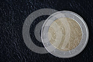 Coin in two euros on a dark background