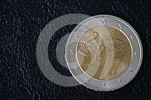 Coin in two euros on a dark background