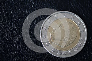 Coin in two euros on a dark background