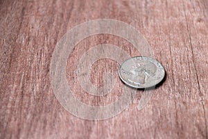 Coin of United stage of America on the wooden floor, Quarter dollar of USA money the concept of finance.