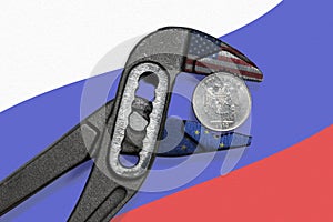 The coin in vise on the background of flag of Russia