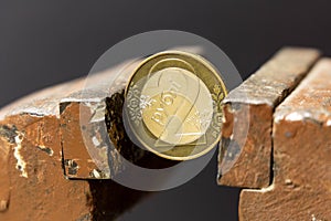 Coin in a vise. Belarusian rubles in a metal vise. Economic problem