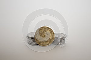 A coin worth twenty-five Ukrainian kopecks. coin on a white background is standing upright