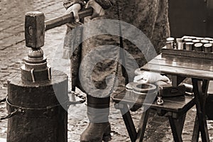 Coinage craftsman stamping coins with hammer and anvil. Retro style concept photo