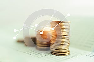 coins on account book in soft focus with increasing graph for finance ,saving , investment and banking concept