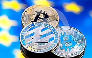 Coins Bitcoin and litecoin, against the background of Europe and