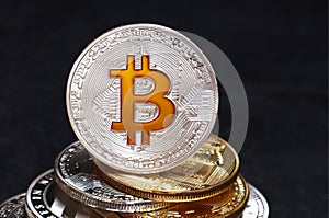 Coins of Bitcoin and Litecoin on a black textured background
