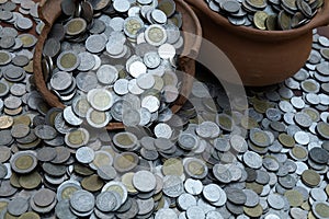 Coins in broken jar from on pile lots coin with blurred background, Money stack for business planning investment and saving