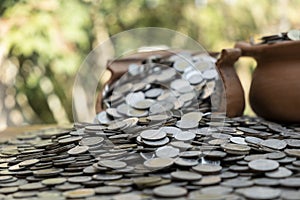 Coins in broken jar from on pile lots coin with blurred background, Money stack for business planning investment and saving