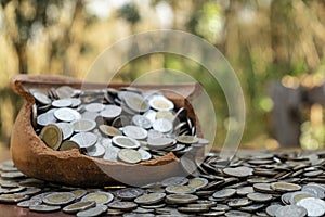 Coins in broken jar from on pile lots coin with blurred background, Money stack for business planning investment and saving