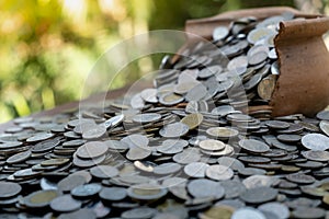 Coins in broken jar from on pile lots coin with blurred background, Money stack for business planning investment and saving