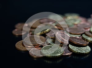 Bulk of european coins with closeup on black background with copy space photo