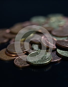 Bulk of european coins with closeup on black background with copy space photo