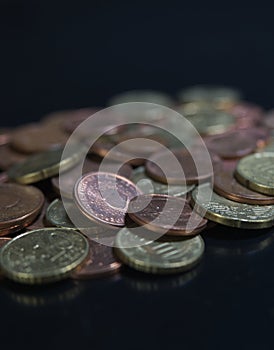 Bulk of european coins with closeup on black background with copy space photo