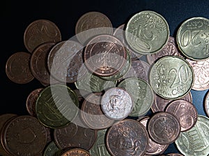 Bulk of european coins from topview on black background with copy space photo