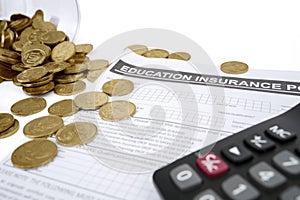 Coins with calculator and education insurance form