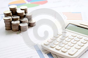 Coins, chart and a calculator as a symbol for exchange rates.