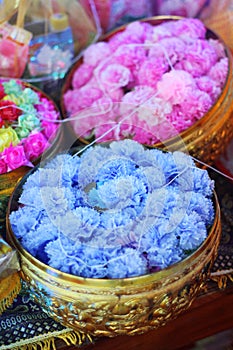 Coins in colorful ribbin in a gold bowl for Newly ordained Buddhist monks