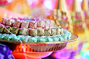 Coins in colorful ribbin in a gold bowl for Newly ordained Buddhist monks