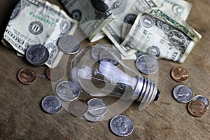 Coins and crumpled money tungsten lamp