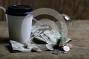 Coins and crumpled money tungsten lamp filament