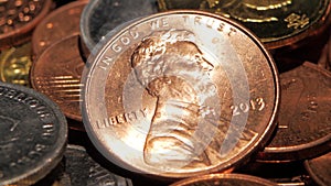 Coins in a dark room shines from them falling on the light. Close up