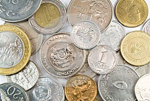 Coins of different nations on white background