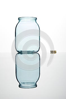 Coins and empty glass jar