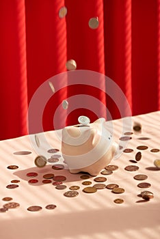 Coins falling into piggy bank. Money savings concept