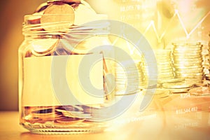 Coins in glass jar with empty label for money saving financial