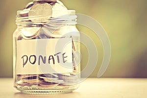 Coins in glass jar for giving and donation concept