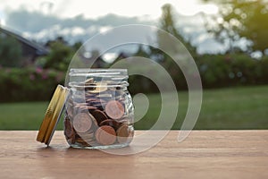 Coins in glass jar for money saving financial concept.Saving money for investing and for the future