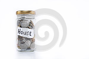 Coins in a glass jar with note written ` SAVING `