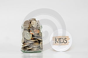 Coins in glass jar, saving money for their Kids