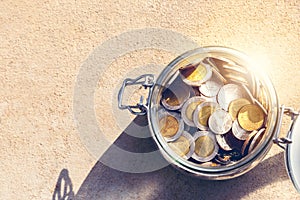 Coins in glass jar top view