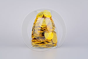 coins in glass jars, high exchange rate investment and gold stocks