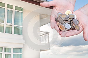 Coins in hands money Savings and apartment ,condominium