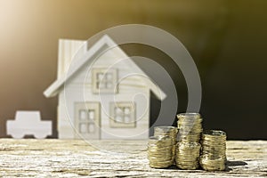 Coins and house blur background show savings money