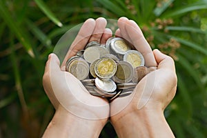 Coins in human hands, Save money for the future business, investment and finance concept