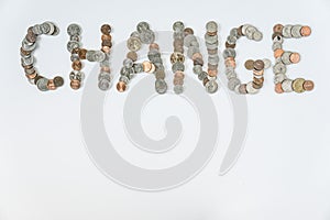 Coins isolated on solid white background spelling the word Change