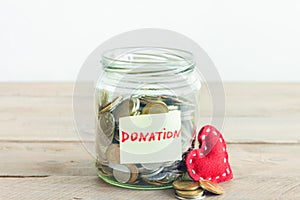 Coins in jar with Donation label