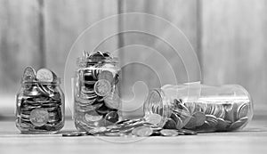 Coins in a jar on the floor. Accumulated coins on the floor. Sav