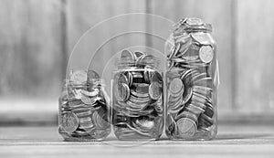 Coins in a jar on the floor. Accumulated coins on the floor. Sav