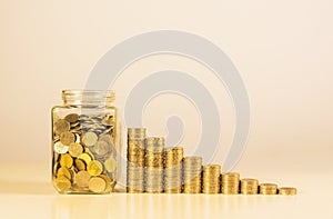 Coins in jar with money stack step growing money