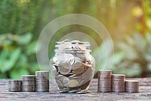 Coins in jar with money stack step growing money, Concept finance business and saving investment.