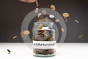 Coins in a jar with retirement text on a label