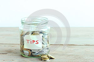 Coins in jar with Tips label
