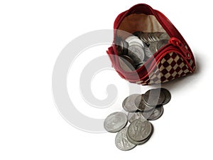 Coins in ladies purse on White background